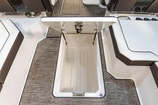 Slide: The Image of 2025 Cobalt R33 boat interior with open storage compartment, featuring sleek design and modern upholstery. - 16
