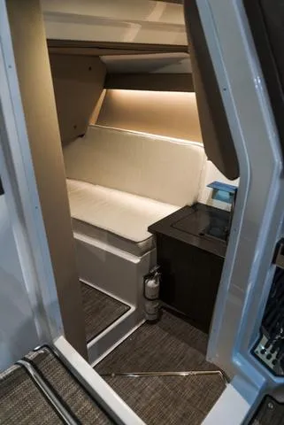 Slide: The Image of Interior cabin of 2025 Cobalt R33 boat with cushioned seating and modern design. - 27