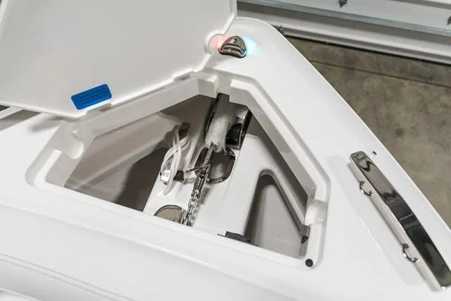 Slide: The Image of Anchor storage compartment on 2025 Cobalt R33 boat, featuring chain and rope. - 33