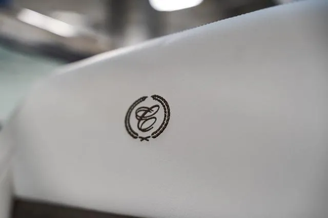 Slide: The Image of Embroidered logo on white leather seat of 2025 Cobalt R33. - 35