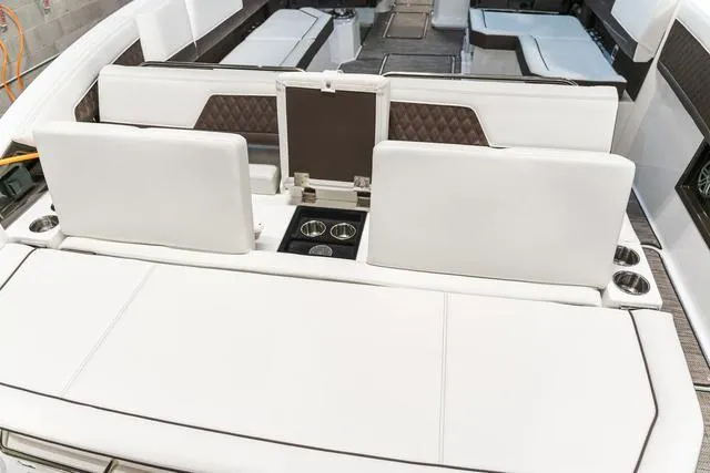 Slide: The Image of 2025 Cobalt R33 boat interior with white seating and cup holders. - 5