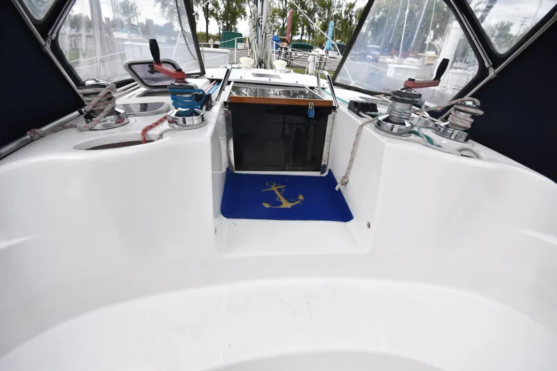 Slide: The Image of Cockpit of 2003 Hunter 386 sailboat with winches and anchor-themed mat. - 26