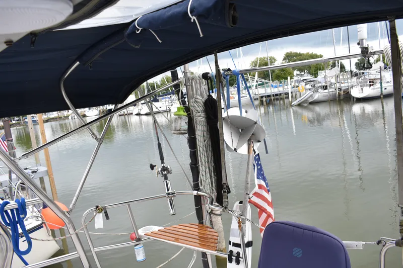 Slide: The Image of Sailboat cockpit view, Hunter 386, 2003 model, docked in marina with American flag. - 16