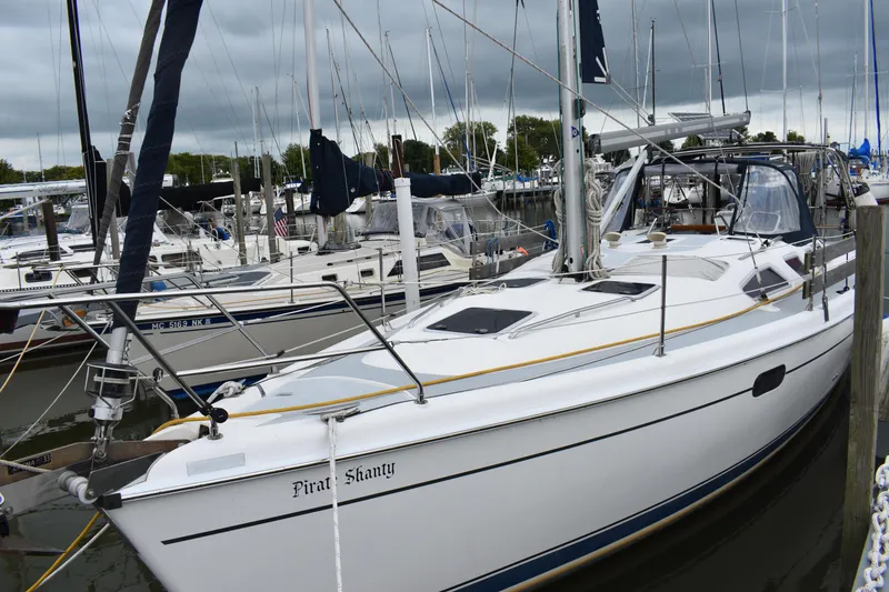 Slide: The Image of 2003 Hunter 386 sailboat docked in marina, overcast sky. - 8