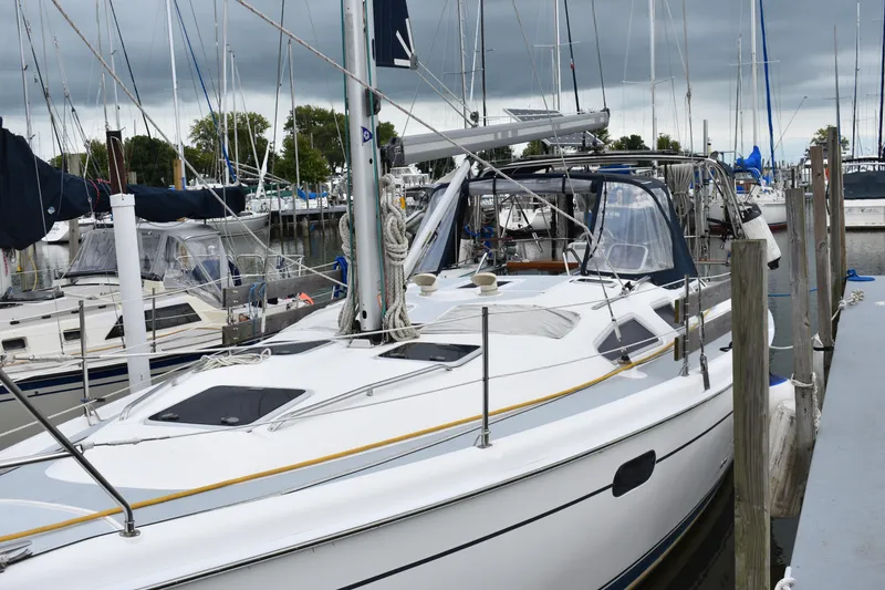 Slide: The Image of 2003 Hunter 386 sailboat docked at marina under cloudy skies. - 9