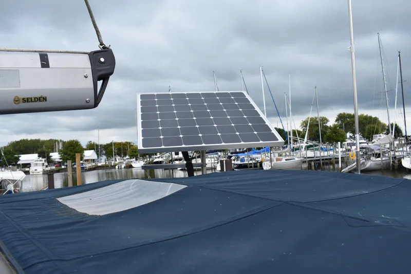 Slide: The Image of Sailboat with solar panel, Hunter 386, 2003 model, docked at marina under cloudy sky. - 15