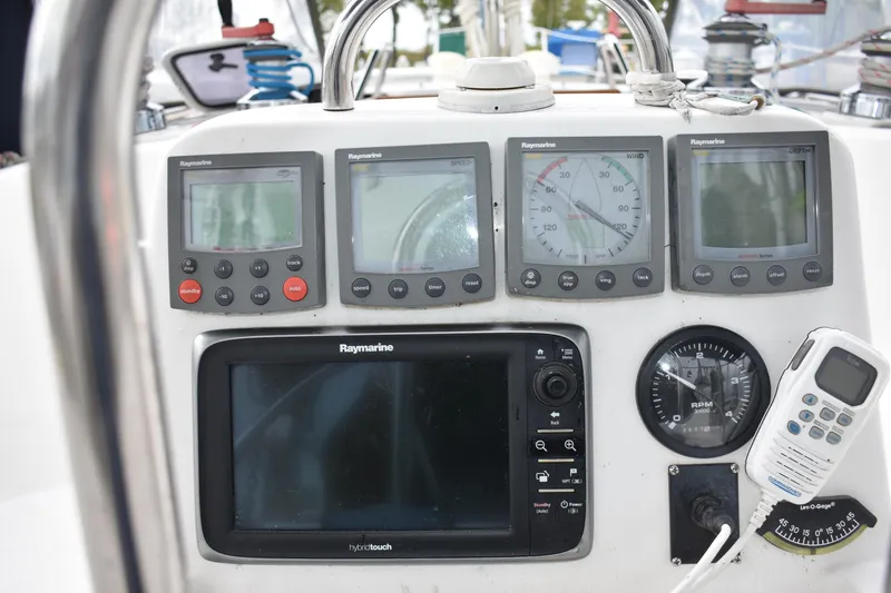 Slide: The Image of Control panel of a 2003 Hunter 386 sailboat with navigation instruments and a marine radio. - 23