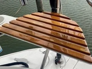Slide: The Image of Polished wooden seat on a 2003 Hunter 386 sailboat deck. - 22