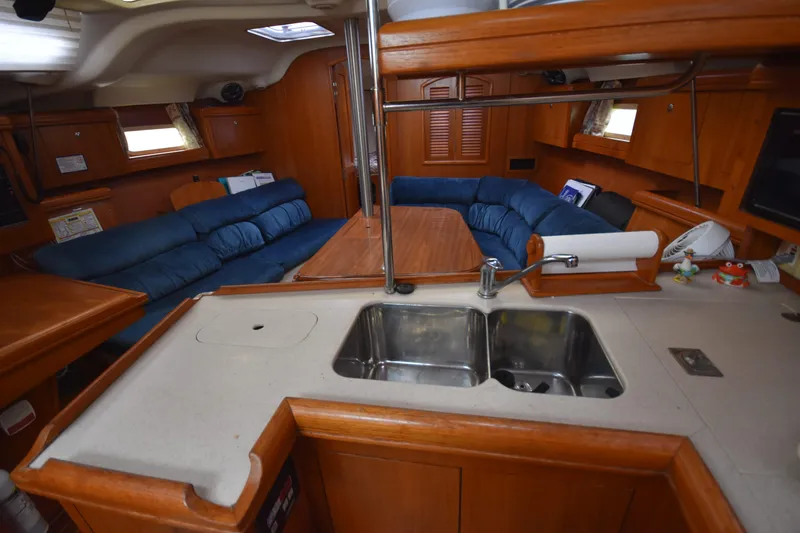 Slide: The Image of Interior of 2003 Hunter 386 sailboat with kitchen sink and cozy seating area. - 33