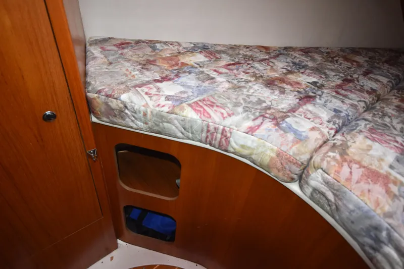 Slide: The Image of Interior cabin of 2003 Hunter 386 sailboat with patterned mattress and wooden storage. - 47