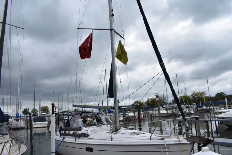 Slide: The Image of Sailboat Hunter 386, 2003 model, docked in a marina under cloudy skies. - 7