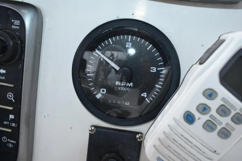 Slide: The Image of RPM gauge on a 2003 Hunter 386 boat dashboard with control panel. - 25