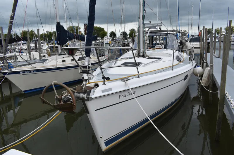 Slide: The Image of 2003 Hunter 386 sailboat docked in a marina, overcast sky. - 0