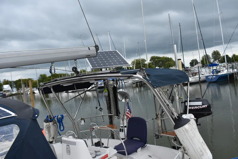 Slide: The Image of Sailboat docked at marina, Hunter 386 model, 2003, with solar panel and Mercury engine. - 14