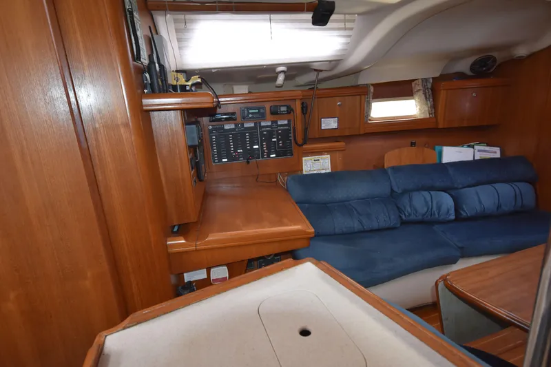 Slide: The Image of Interior of 2003 Hunter 386 sailboat with wooden cabinetry and blue seating. - 35