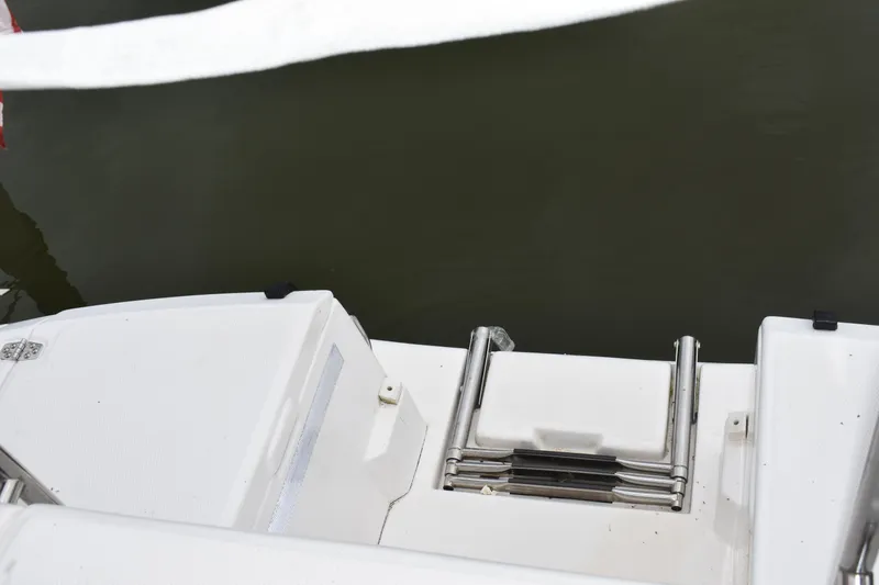 Slide: The Image of 2003 Hunter 386 boat swim platform with ladder, docked on calm water. - 21