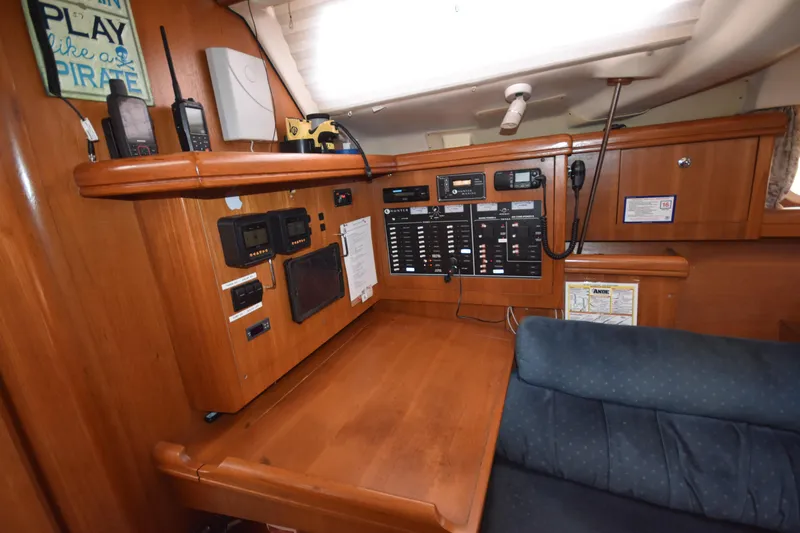Slide: The Image of Control panel inside a 2003 Hunter 386 sailboat, featuring navigation and communication equipment. - 42