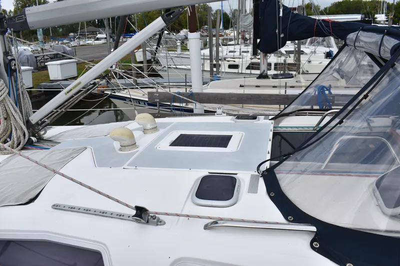 Slide: The Image of 2003 Hunter 386 sailboat deck with marina background. - 11