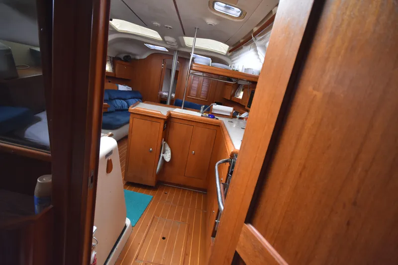 Slide: The Image of Interior of 2003 Hunter 386 sailboat with wooden cabinetry and cozy layout. - 46