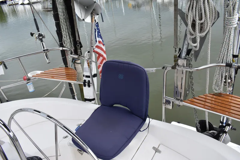 Slide: The Image of 2003 Hunter 386 sailboat cockpit with blue seat and American flag. - 19