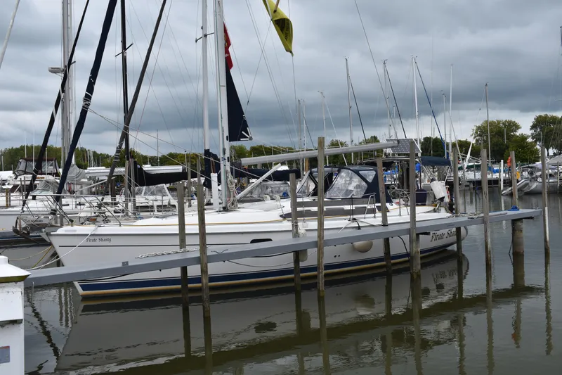 Slide: The Image of 2003 Hunter 386 sailboat docked in a marina under cloudy skies. - 3