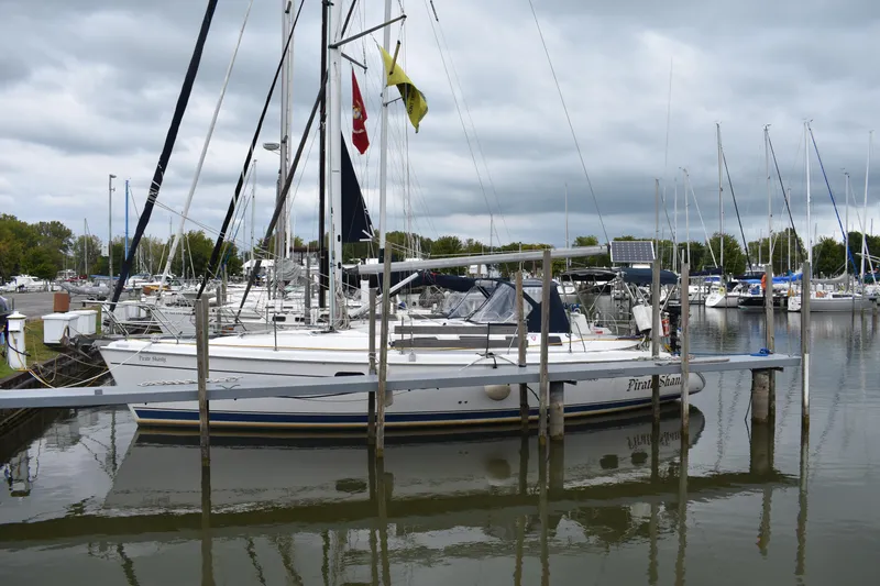 Slide: The Image of 2003 Hunter 386 sailboat docked in a marina under cloudy skies. - 4