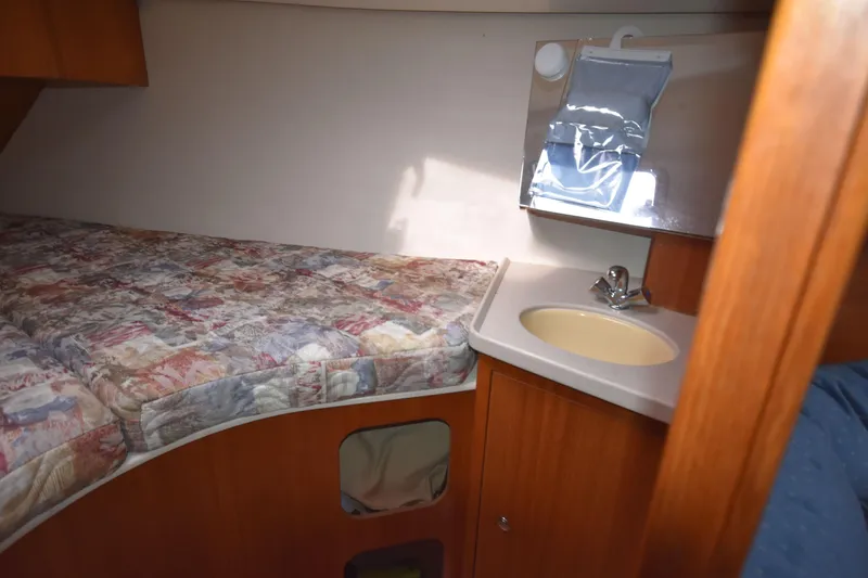 Slide: The Image of Cozy cabin interior of 2003 Hunter 386 sailboat with bed and sink. - 49