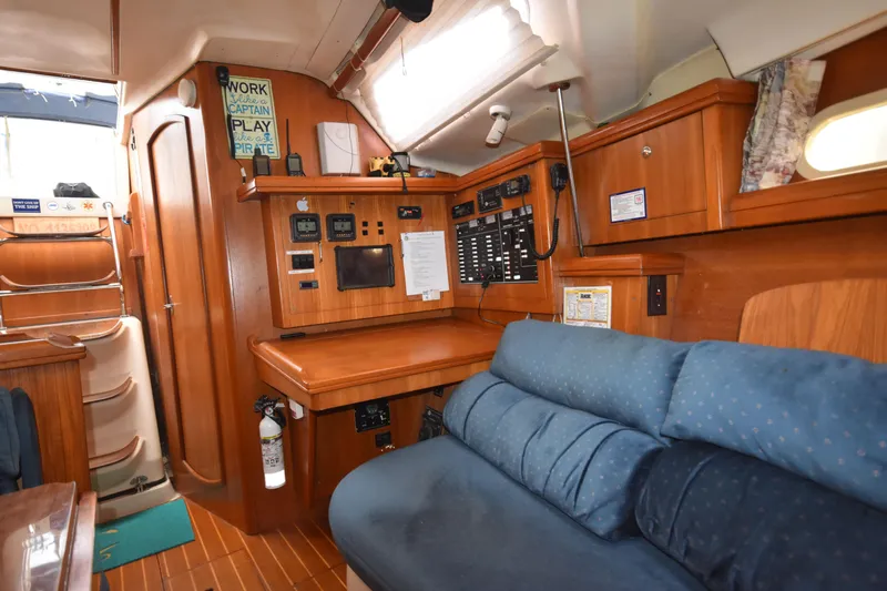 Slide: The Image of Interior of 2003 Hunter 386 sailboat with navigation station and cozy seating area. - 41