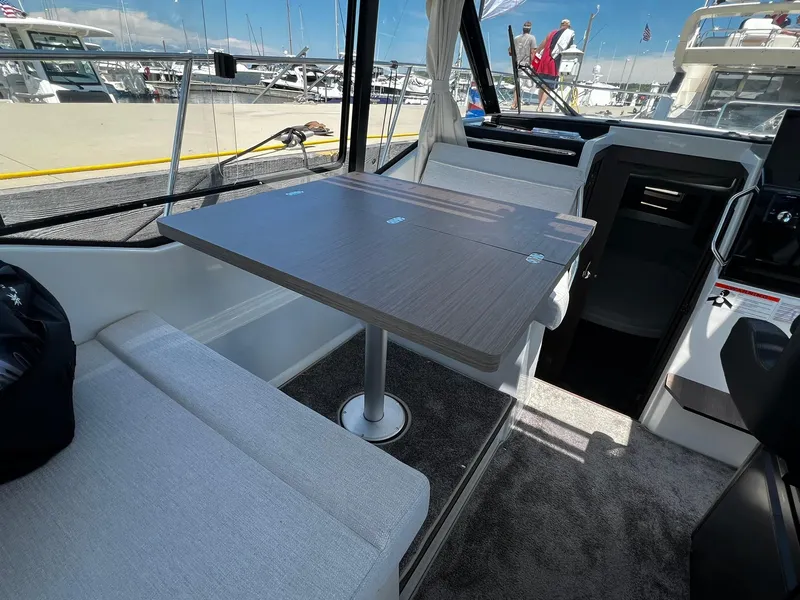 Slide: The Image of Interior of 2025 Jeanneau NC 895 boat with dining table and seating area. - 10
