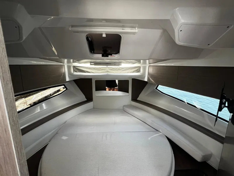 Slide: The Image of Interior of 2025 Jeanneau NC 895 boat, featuring modern cabin design and comfortable seating. - 23