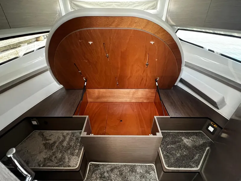 Slide: The Image of 2025 Jeanneau NC 895 interior cabin with wood finish and carpeted steps. - 25