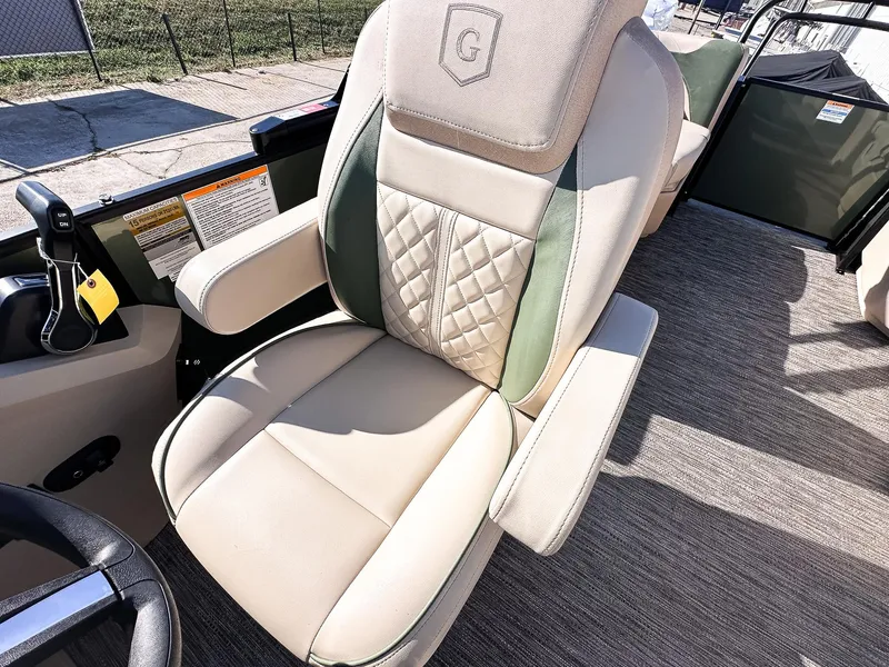 Slide: The Image of Captain's chair on 2025 Godfrey Sweetwater Tritoon, featuring beige and green upholstery. - 12