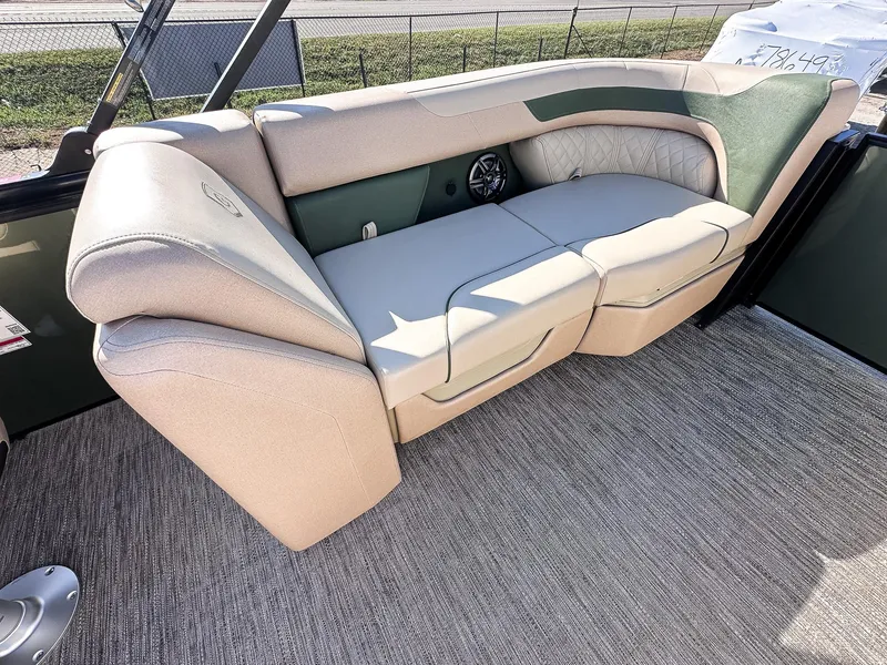 Slide: The Image of Luxurious seating on 2025 Godfrey Sweetwater Tritoon, featuring beige and green upholstery. - 13