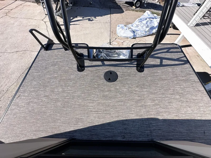 Slide: The Image of 2025 Godfrey Sweetwater Tritoon deck with textured flooring and sturdy railing. - 14