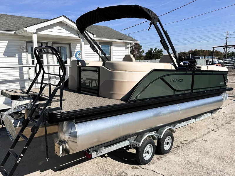 Slide: The Image of 2025 Godfrey Sweetwater 2286 SB Tritoon boat on trailer, featuring split bench seating. - 17
