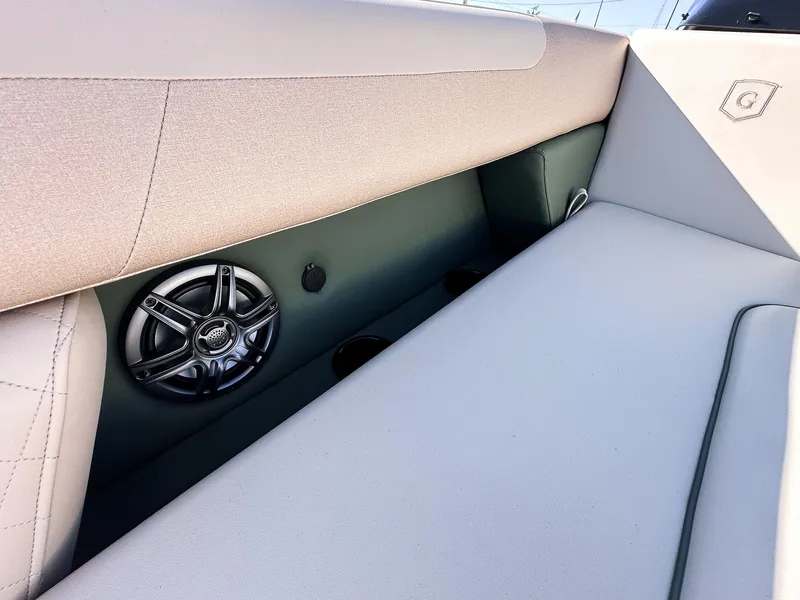 Slide: The Image of 2025 Godfrey Sweetwater Tritoon interior with speaker and cushioned seating. - 8