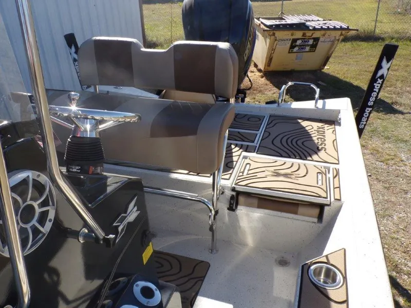 Slide: The Image of 2025 Xpress H24Bay boat interior with seating and deck details. - 13