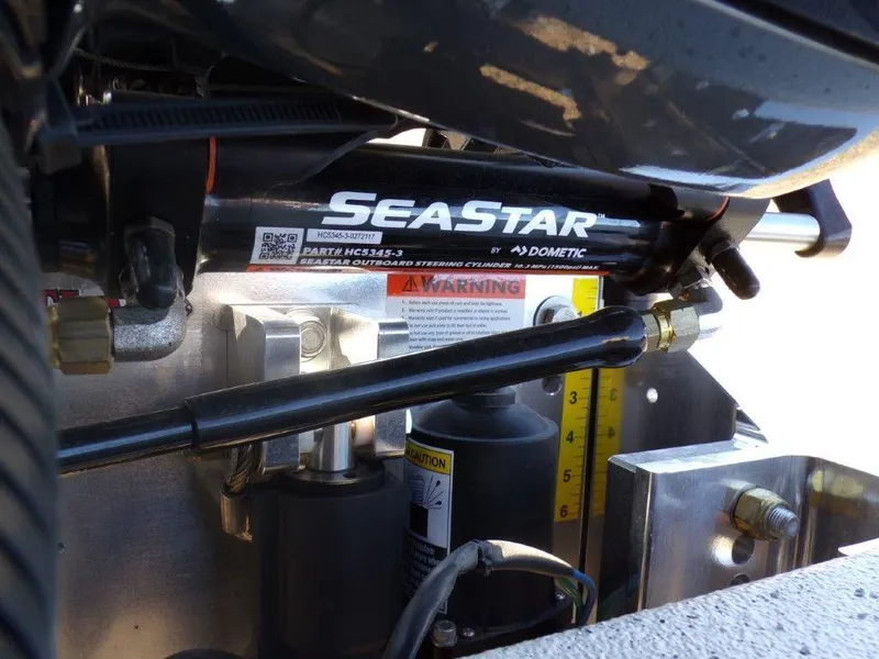 Slide: The Image of Close-up of SeaStar hydraulic steering system in 2025 Xpress H24Bay boat. - 24