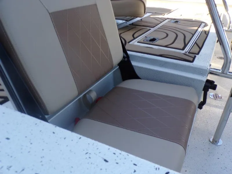 Slide: The Image of 2025 Xpress H24Bay boat seat with tan and brown upholstery, featuring diamond stitching. - 7