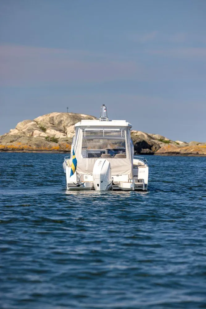 Slide: The Image of 2024 Nimbus W9 boat on open water near rocky shoreline. - 11