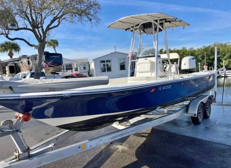 Slide: The Image of 2015 Sea Born FX24 Bay boat on trailer, parked outdoors. - 1