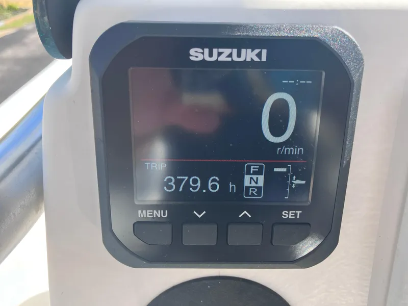 Slide: The Image of Suzuki digital display on 2015 Sea Born FX24 Bay boat showing 379.6 hours. - 14