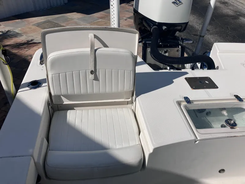 Slide: The Image of 2015 Sea Born FX24 Bay boat with white cushioned seating and motor. - 18