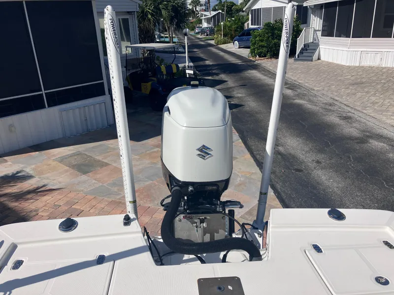 Slide: The Image of 2015 Sea Born FX24 Bay boat with outboard motor, parked in residential area. - 23