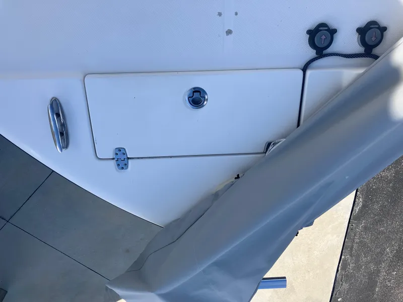 Slide: The Image of 2015 Sea Born FX24 Bay boat deck with storage compartment and cleat. - 24