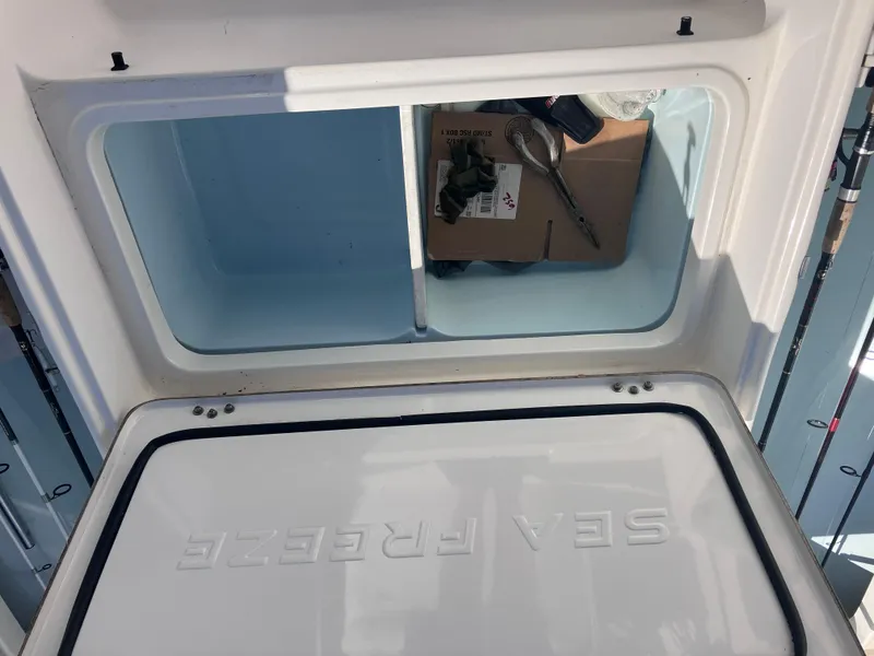 Slide: The Image of Open storage compartment on 2015 Sea Born FX24 Bay boat. - 29