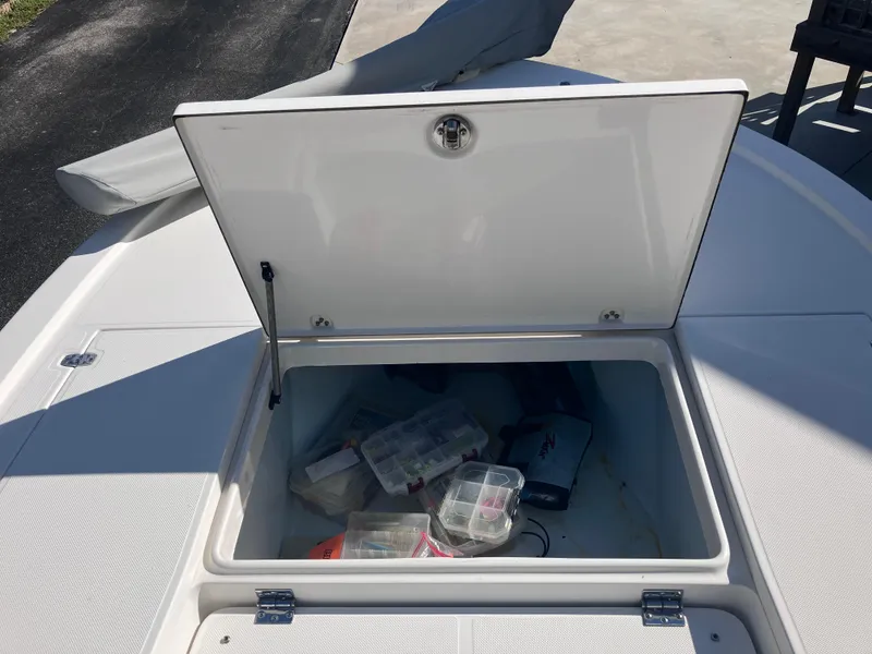 Slide: The Image of Open storage compartment on 2015 Sea Born FX24 Bay boat with fishing gear. - 30