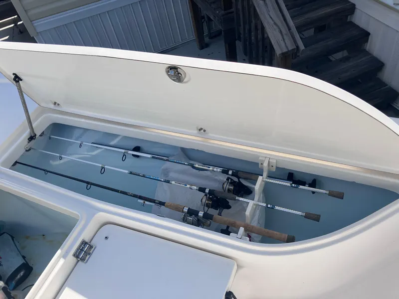 Slide: The Image of 2015 Sea Born FX24 Bay boat with fishing rod storage compartment open. - 32