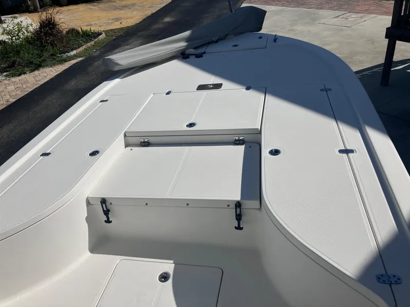 Slide: The Image of 2015 Sea Born FX24 Bay boat deck with storage compartments in sunlight. - 33