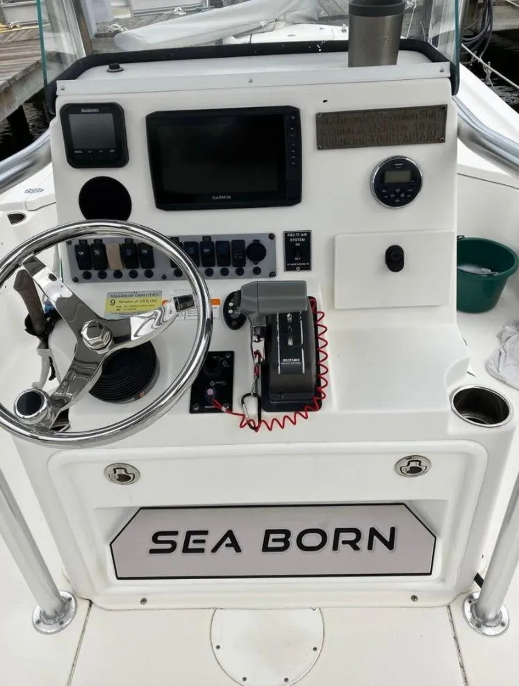 Slide: The Image of 2015 Sea Born FX24 Bay boat console with steering wheel and navigation controls. - 4